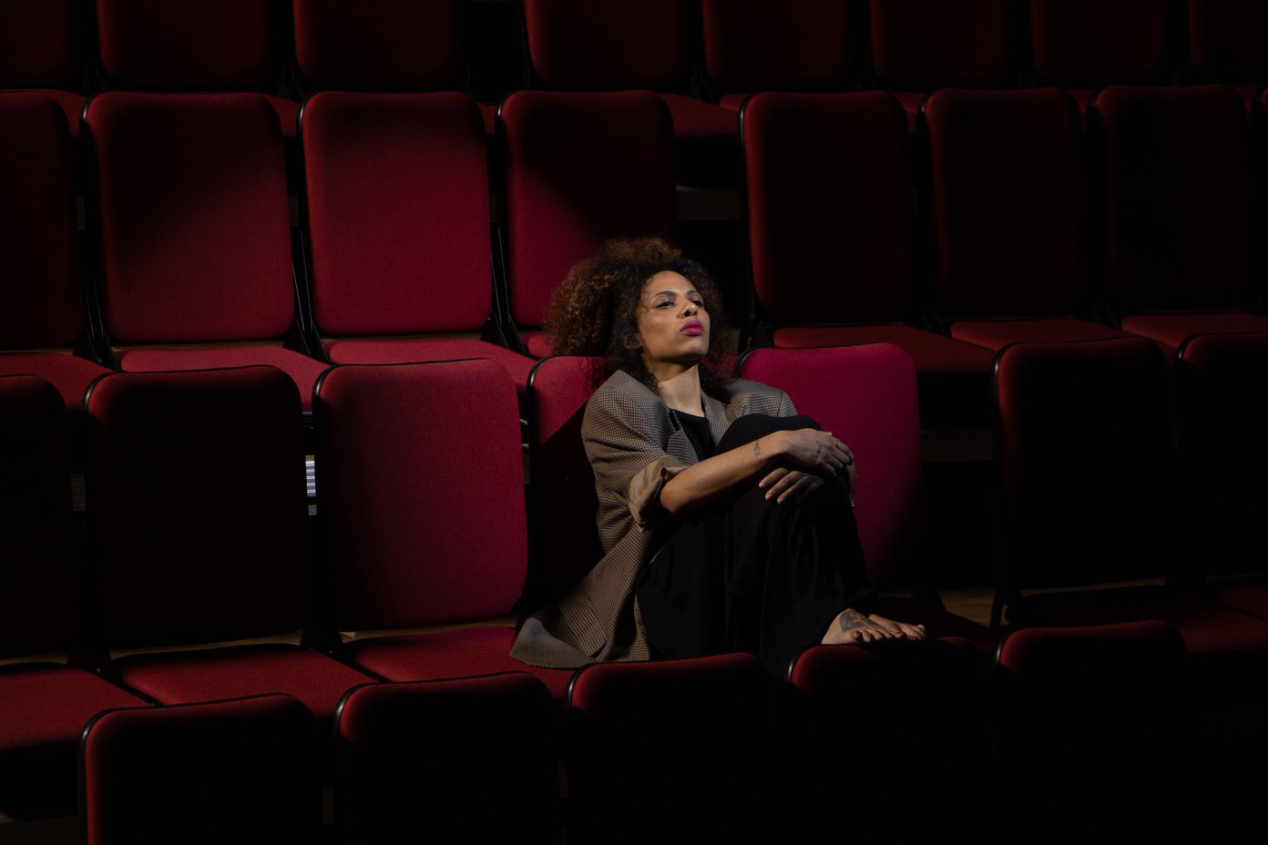 Woman Sitting Alone in Theatre